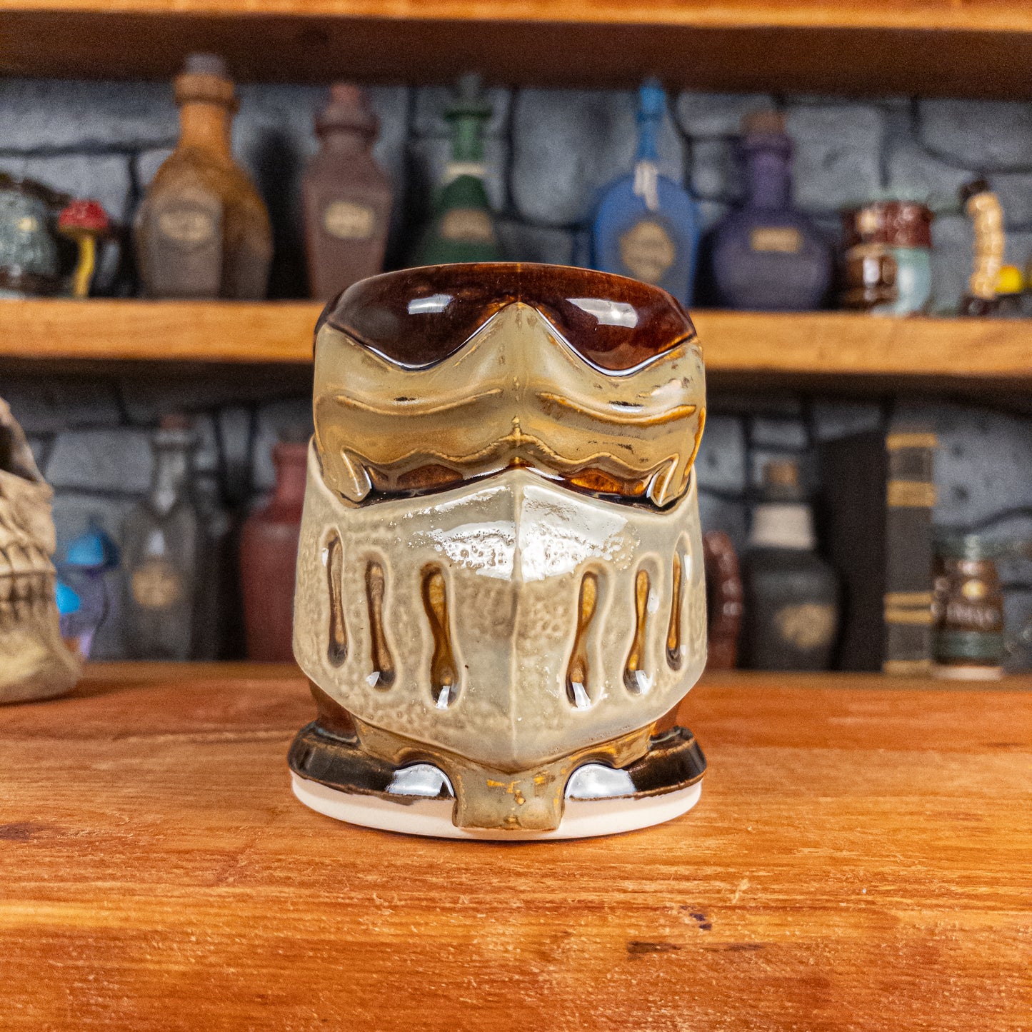 Front view of a handmade Knight Helmet Mug with a brown, beige and grey armour design.