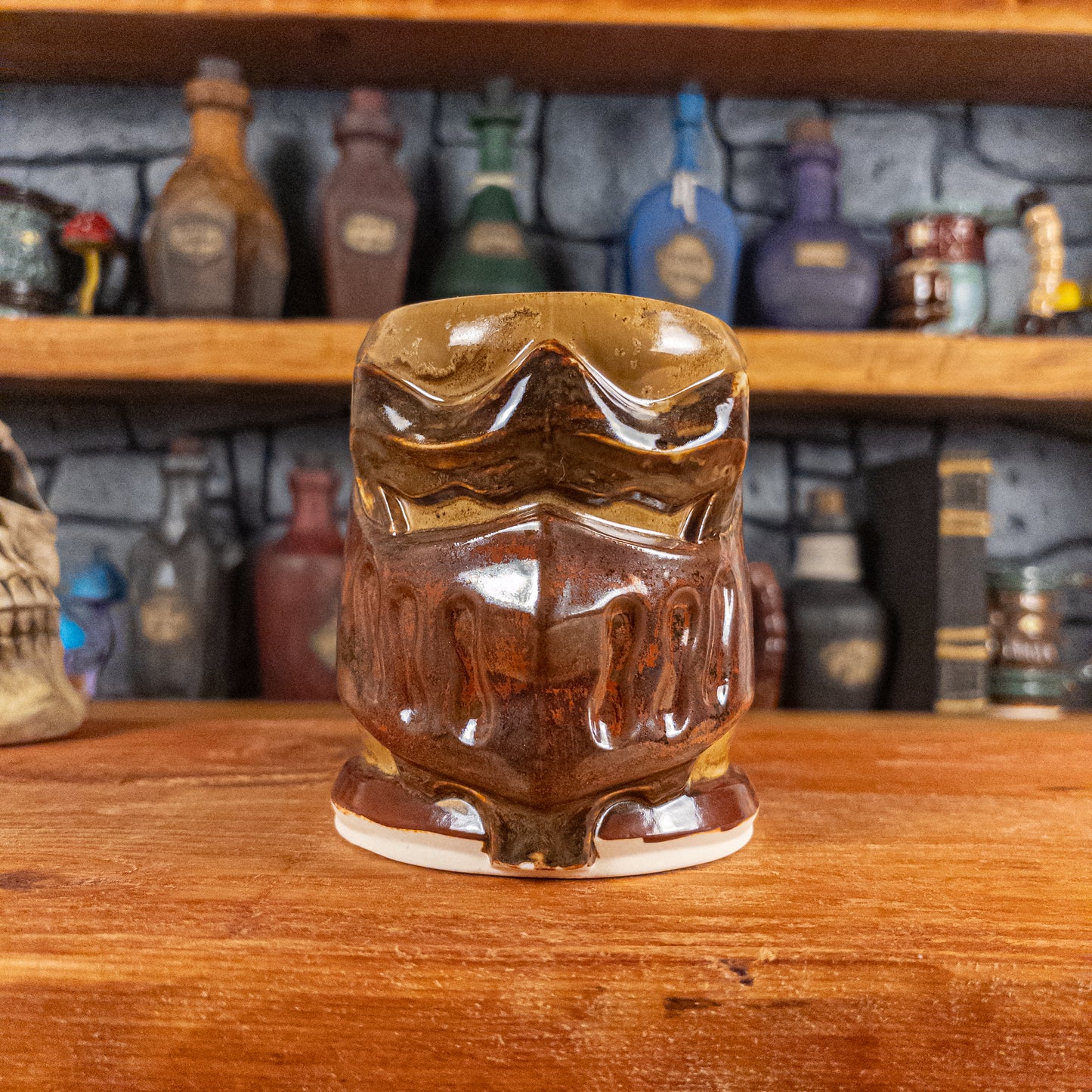 Front view of a handmade Knight Helmet Mug with a brown and rusted armour design and brown eye slits.