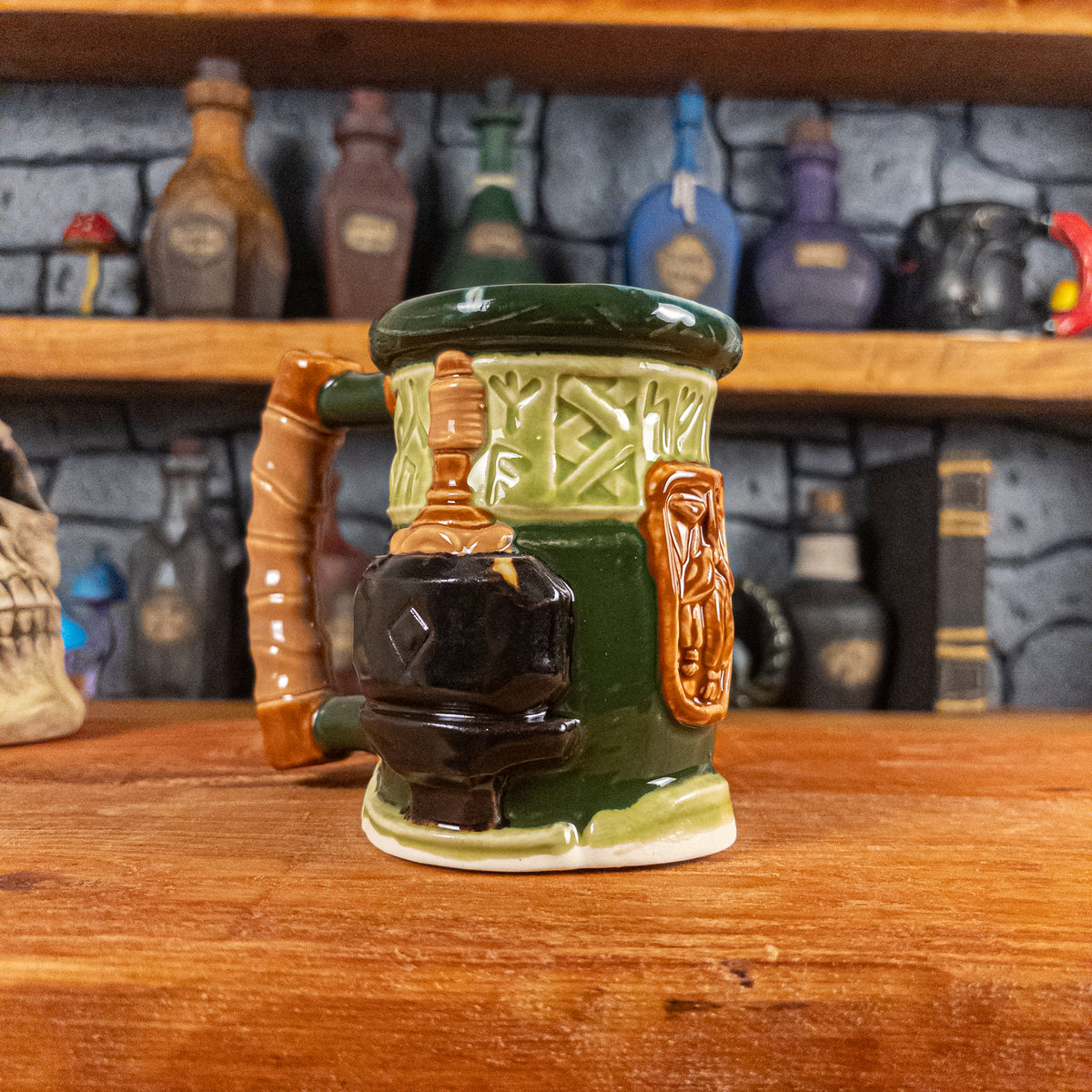 Three-quarter left side view of a handmade Dwarven Mug designed to look like a light and dark green barrel with intricate rune carvings, a light brown dwarf face, and a hammer and anvil design, showing the detailed handle.