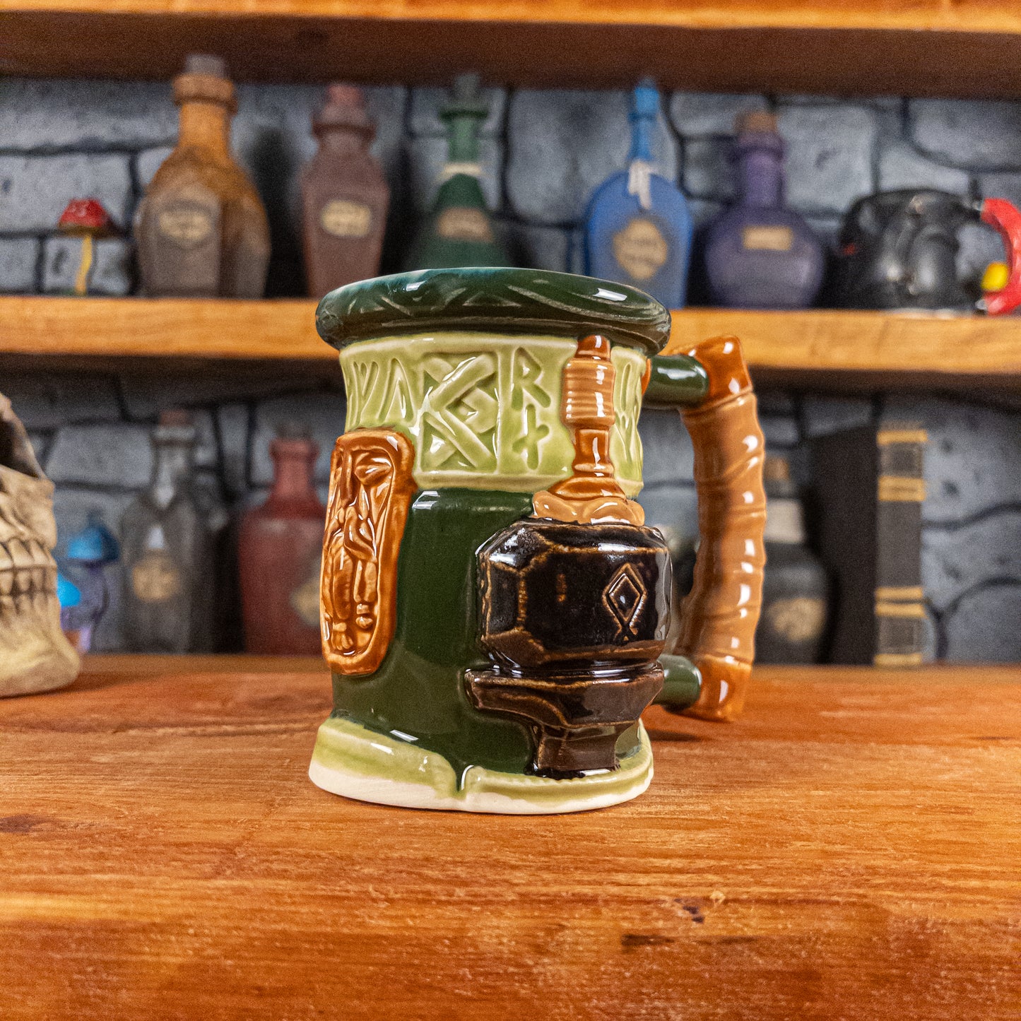 Three-quarter right side view of a handmade Dwarven Mug designed to look like a light and dark green barrel with intricate rune carvings, a light brown dwarf face, and a hammer and anvil design, showing the detailed handle.