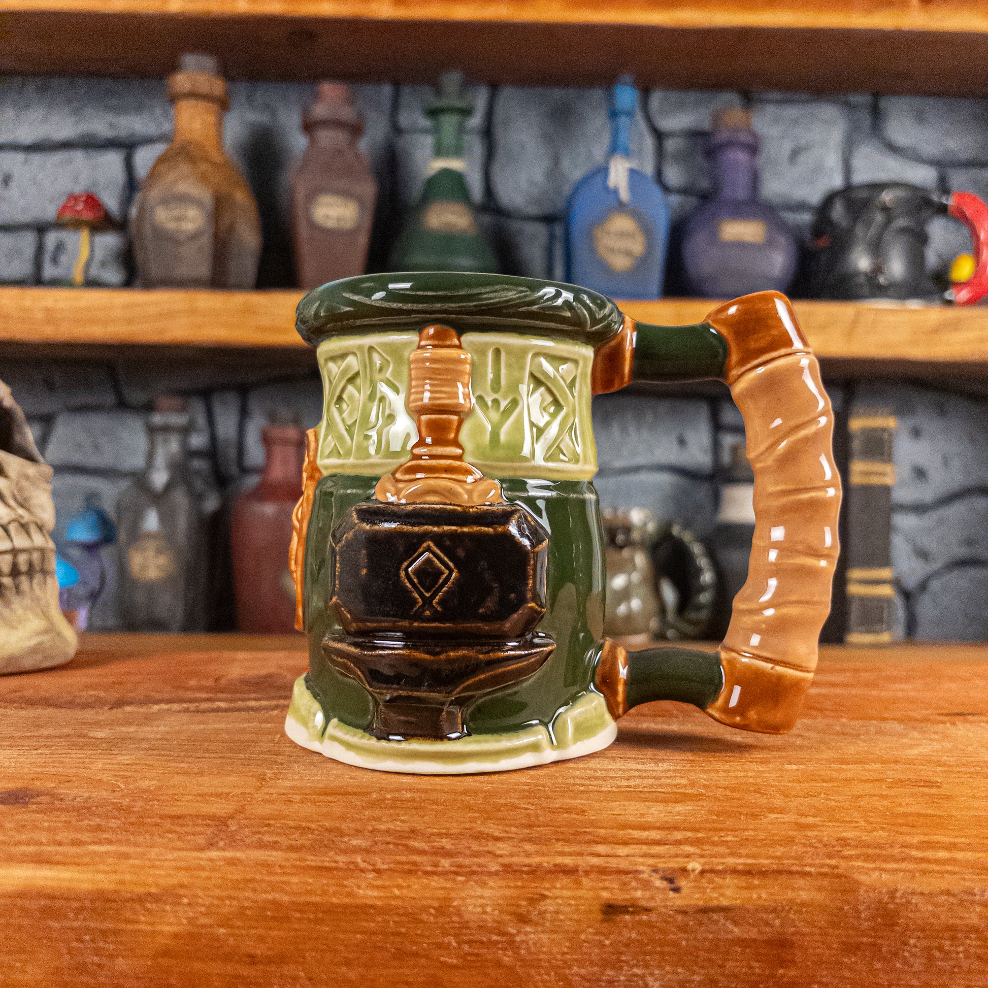 The right side view of a handmade Dwarven Mug designed to look like a light and dark green barrel with intricate rune carvings, a partial light brown dwarf face, and a hammer and anvil design, showing the detailed handle.