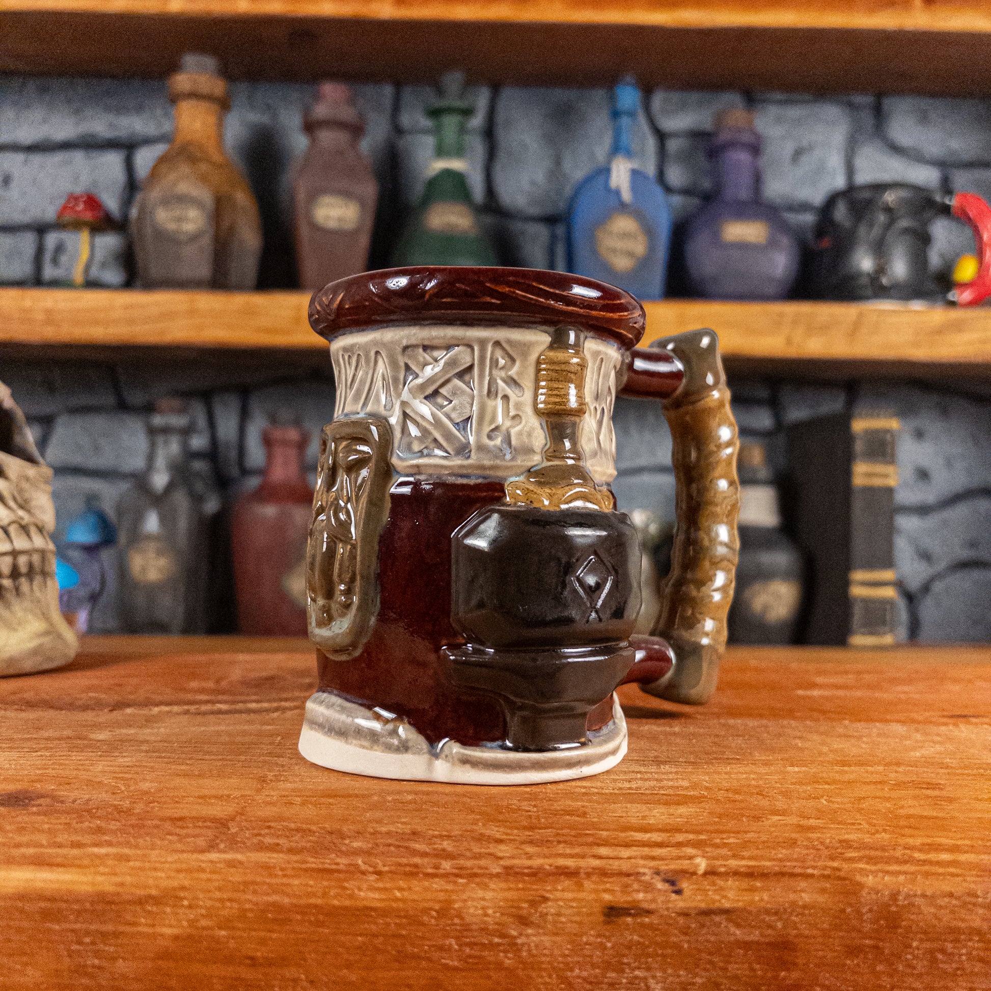 Three-quarter right side view of a handmade Dwarven Mug designed to look like a wine red and light sand barrel with intricate rune carvings, a dark brown dwarf face, and a hammer and anvil design, showing the detailed handle.