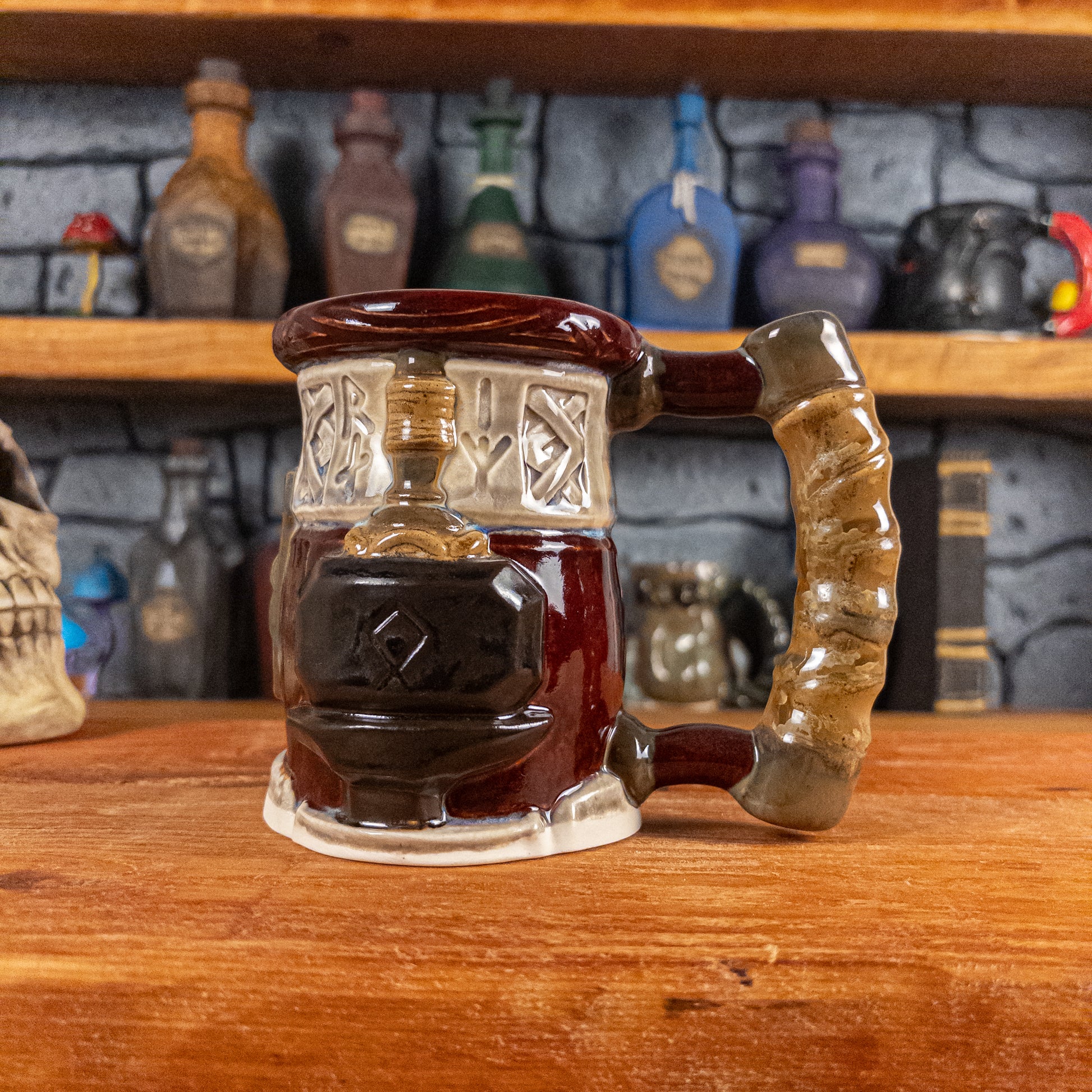 The right side view of a handmade Dwarven Mug designed to look like a wine red and light sand barrel with intricate rune carvings, a partial dark brown dwarf face, and a hammer and anvil design, showing the detailed handle.