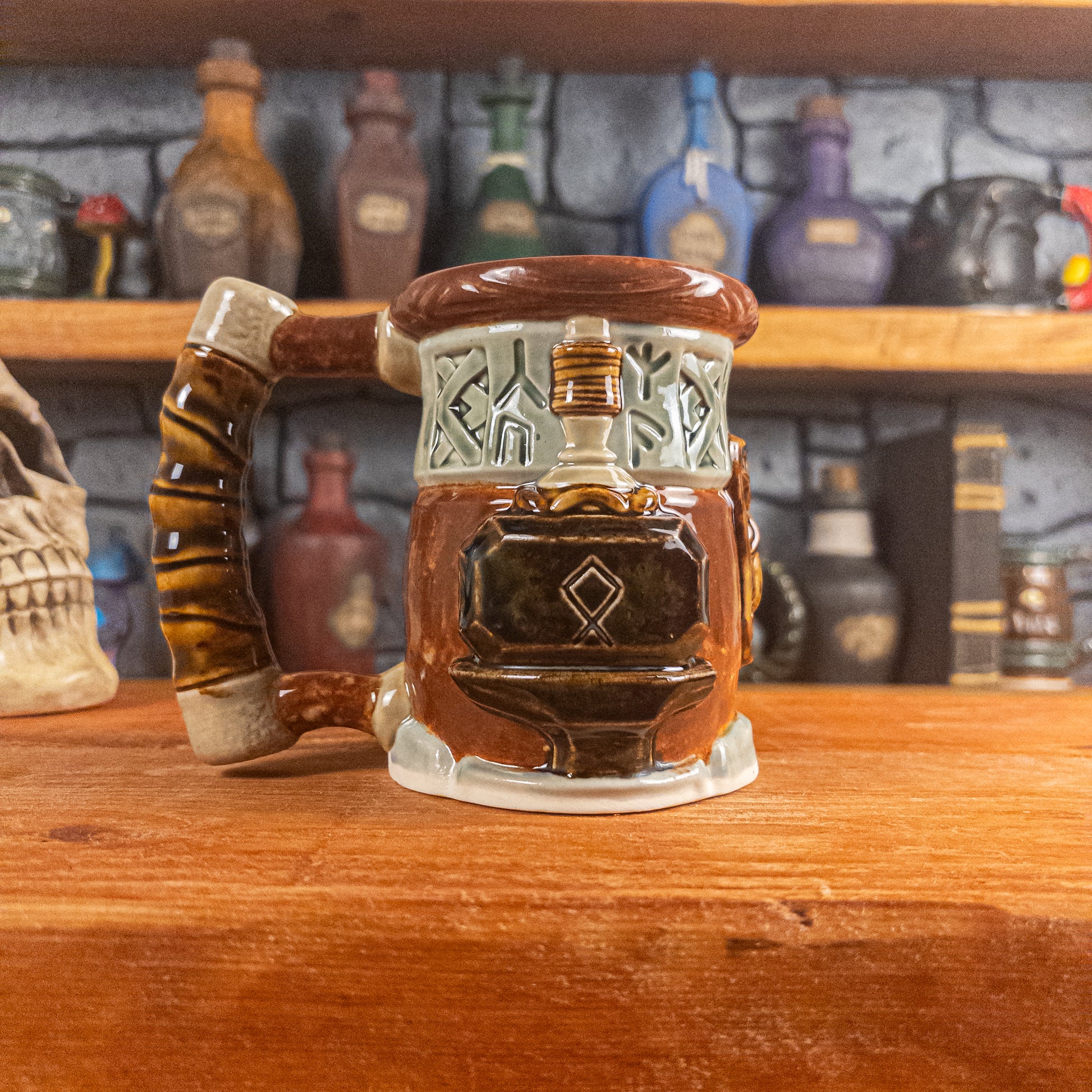 Left side view of a handmade Dwarven Mug designed to look like a light green and reddish-brown barrel with intricate rune carvings, a partial dwarf face, and a hammer and anvil design, showing the detailed handle.
