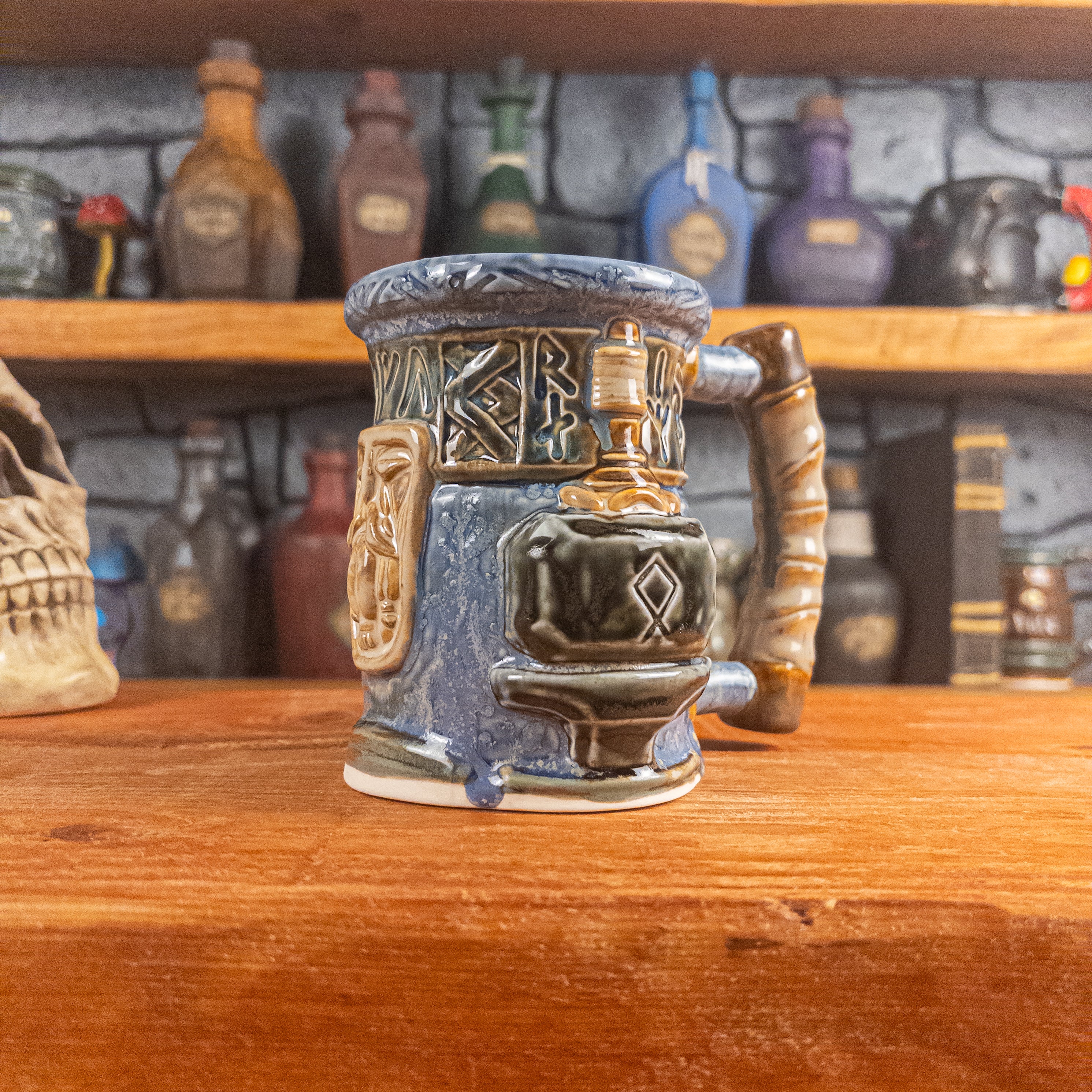 Three-quarter right side view of a handmade Dwarven Mug designed to look like a white-blue and brown-blue barrel with intricate rune carvings, a beige dwarf face, and a hammer and anvil design, showing the detailed handle.