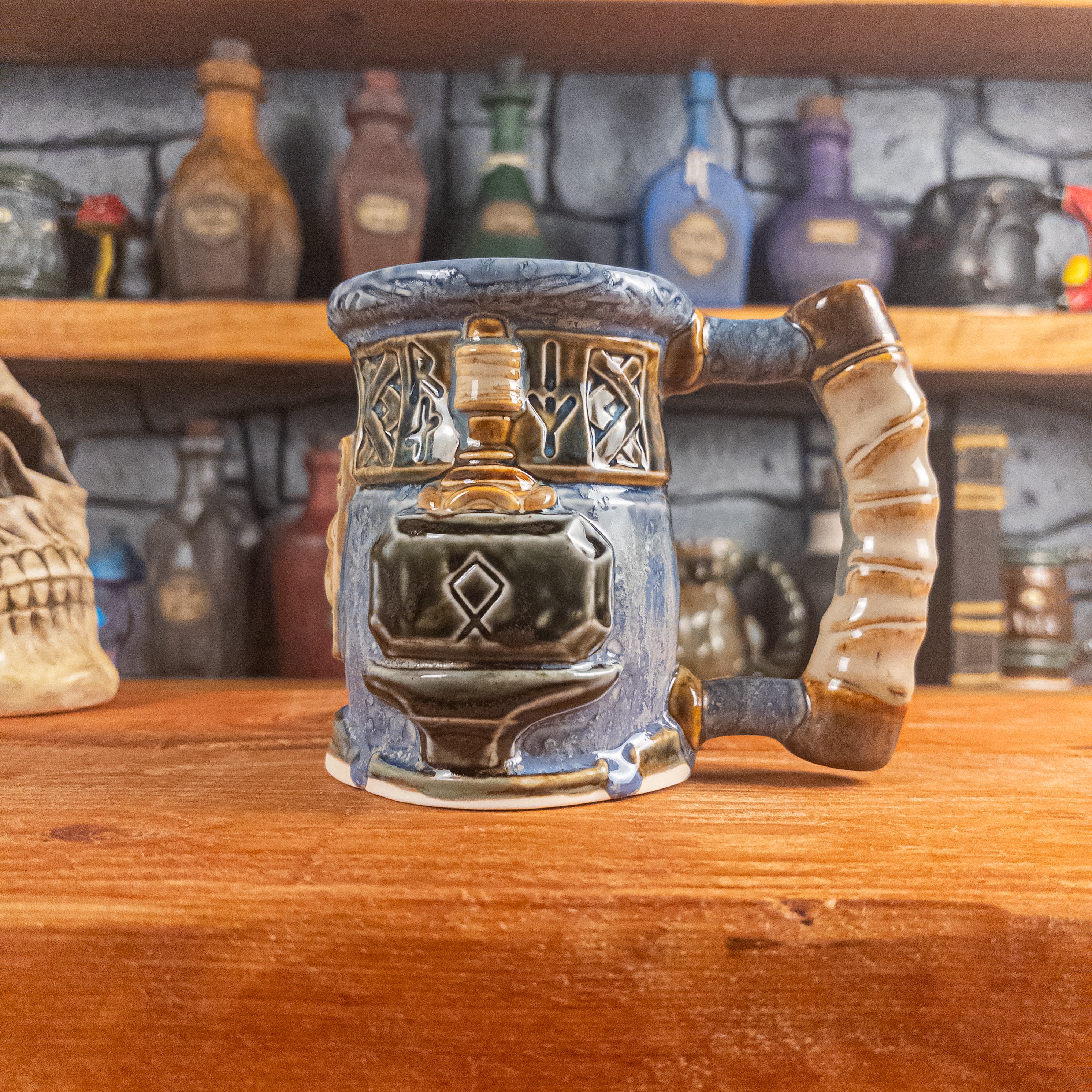 The right side view of a handmade Dwarven Mug designed to look like a white-blue and brown-blue barrel with intricate rune carvings, a partial beige dwarf face, and a hammer and anvil design, showing the detailed handle.